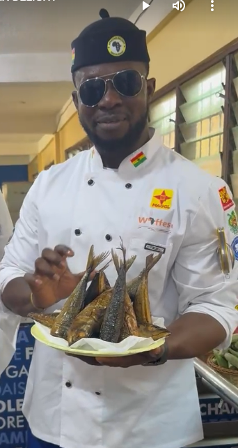 Chef Ernest Kwakuyi Deladem holding smoked fish